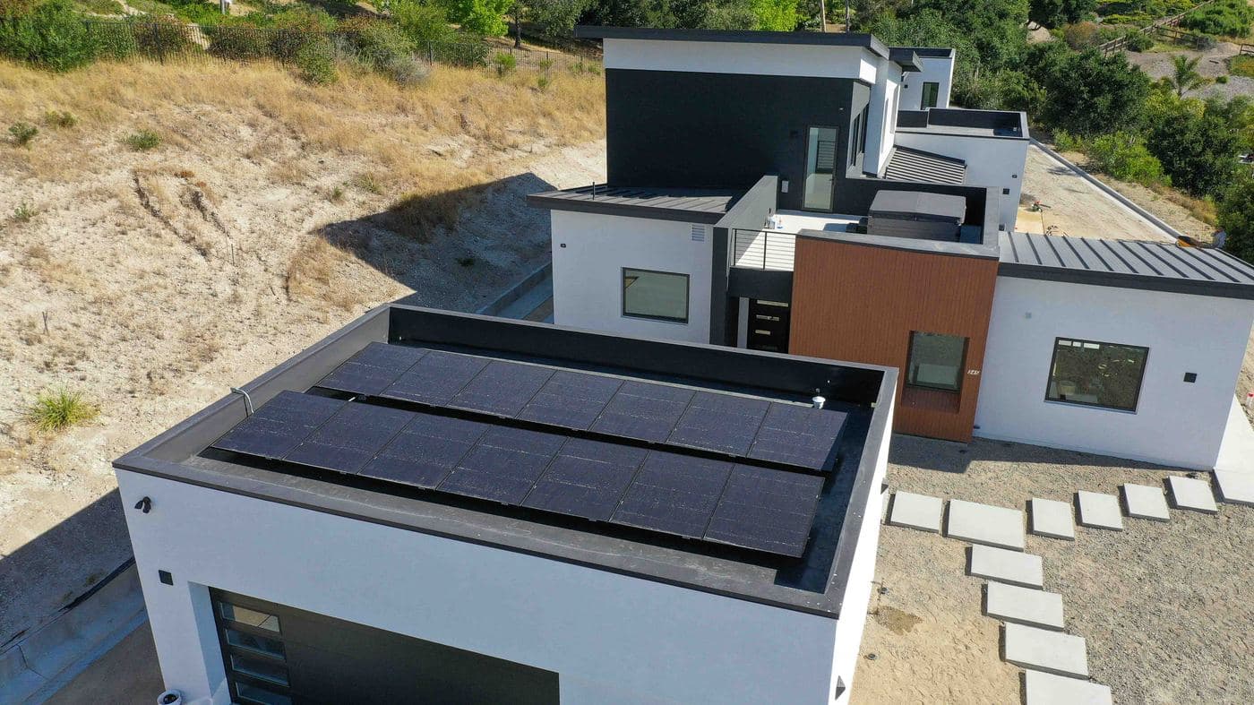 Modern home with REC solar panels on a flat roof
